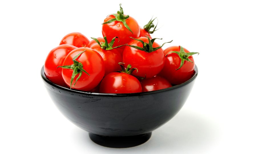 Eine Schüssel mit frischen, roten Tomaten, die Fruchtbarkeit symbolisieren.